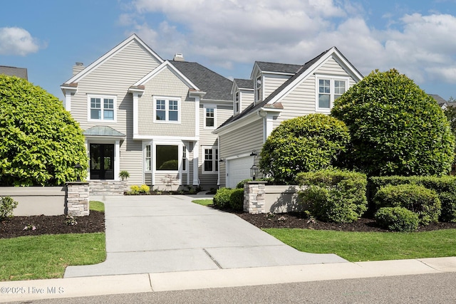 1401 Regatta Dr, Wilmington, NC 28405 - view of front facade featuring a chimney and concrete driveway