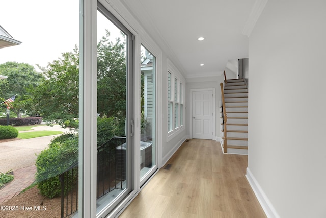 1401 Regatta Dr, Wilmington, NC 28405 - corridor with crown molding, light wood finished floors, baseboards, stairway, and recessed lighting
