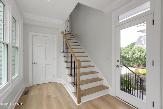 1401 Regatta Dr, Wilmington, NC 28405 - stairway with wood finished floors, crown molding, and baseboards