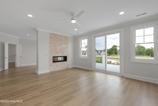 1401 Regatta Dr, Wilmington, NC 28405 - unfurnished living room featuring ornamental molding, a ceiling fan, baseboards, light wood-style flooring, and a fireplace
