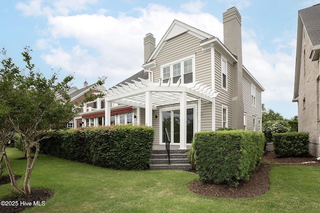 1401 Regatta Dr, Wilmington, NC 28405 - back of house featuring a chimney, a pergola, and a lawn
