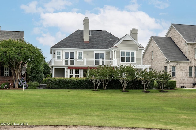 1401 Regatta Dr, Wilmington, NC 28405 - back of property with a yard, a balcony, and a chimney