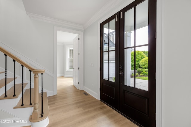1401 Regatta Dr, Wilmington, NC 28405 - entryway featuring french doors, light wood-type flooring, crown molding, stairway, and baseboards
