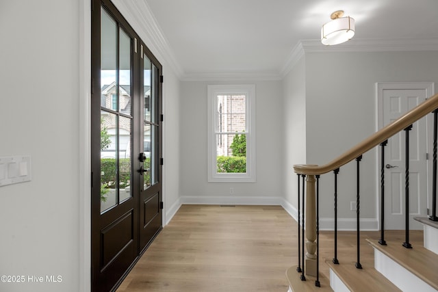 1401 Regatta Dr, Wilmington, NC 28405 - foyer entrance featuring ornamental molding, light wood-style flooring, baseboards, and stairs