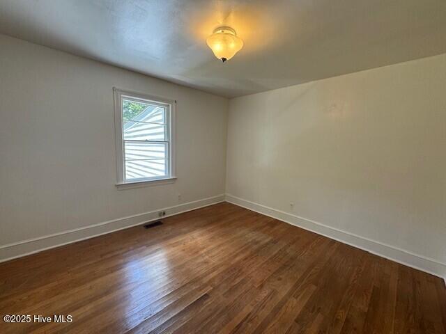 3321 US-13 N, Ahoskie, NC 27910 - spare room featuring baseboards and dark wood-style floors