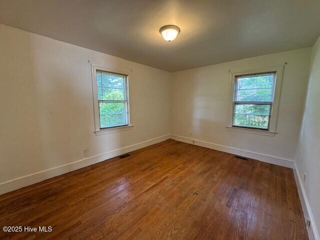 3321 US-13 N, Ahoskie, NC 27910 - unfurnished room featuring healthy amount of natural light, wood finished floors, and baseboards