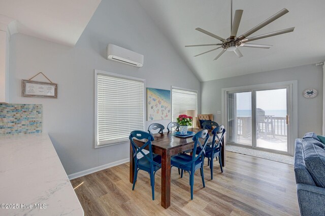 2006 N Shore Dr Unit B, Surf City, NC 28445 - dining space featuring an AC wall unit, ceiling fan, light wood finished floors, high vaulted ceiling, and baseboards