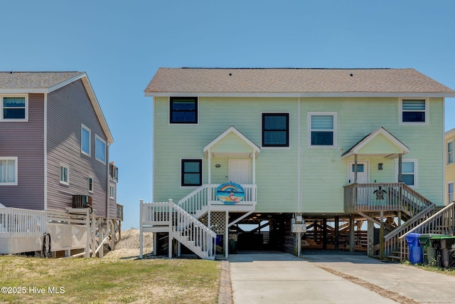 2006 N Shore Dr Unit B, Surf City, NC 28445 - view of front of house featuring stairs, a carport, concrete driveway, and a shingled roof