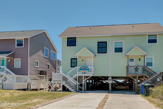 2006 N Shore Dr Unit B, Surf City, NC 28445 - back of property with stairs, a carport, and concrete driveway