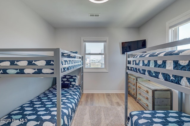 2006 N Shore Dr Unit B, Surf City, NC 28445 - bedroom featuring wood finished floors, multiple windows, and baseboards