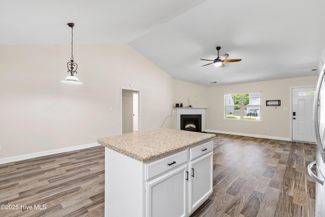 302 Boxwood Ct, Jacksonville, NC 28540 - kitchen featuring a ceiling fan, light wood finished floors, vaulted ceiling, hanging light fixtures, and light countertops