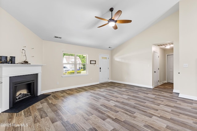 302 Boxwood Ct, Jacksonville, NC 28540 - unfurnished living room with a ceiling fan, vaulted ceiling, wood finished floors, a fireplace, and baseboards
