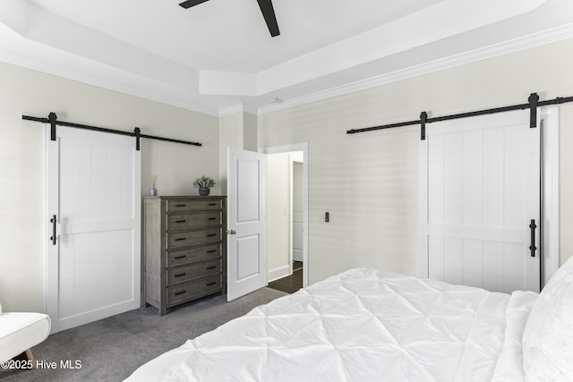 2212 Lakeside Cir, Wilmington, NC 28401 - carpeted bedroom featuring a barn door, a tray ceiling, and a ceiling fan