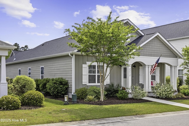 2212 Lakeside Cir, Wilmington, NC 28401 - view of front of property featuring a front yard, covered porch, and board and batten siding