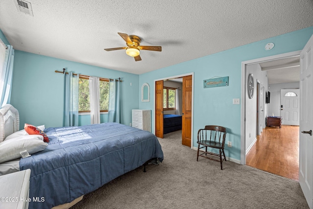 1005 Pirate Cove Cir, Oriental, NC 28571 - carpeted bedroom featuring a textured ceiling and ceiling fan