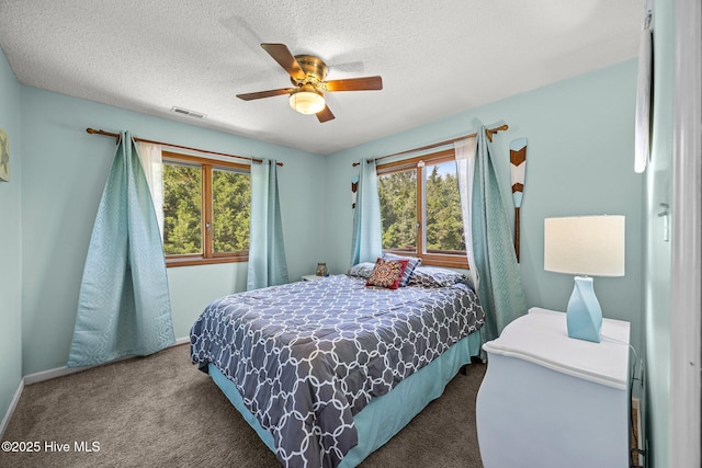 1005 Pirate Cove Cir, Oriental, NC 28571 - bedroom with carpet floors, multiple windows, a ceiling fan, a textured ceiling, and baseboards