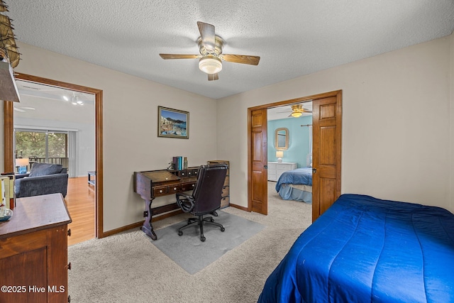 1005 Pirate Cove Cir, Oriental, NC 28571 - carpeted bedroom featuring a desk, a textured ceiling, ceiling fan, and baseboards