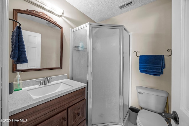 1005 Pirate Cove Cir, Oriental, NC 28571 - bathroom with vanity, toilet, a stall shower, and a textured ceiling