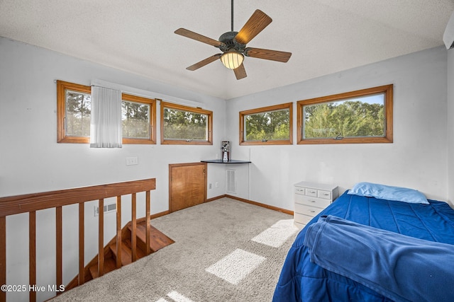1005 Pirate Cove Cir, Oriental, NC 28571 - bedroom with carpet, a textured ceiling, baseboards, and a ceiling fan