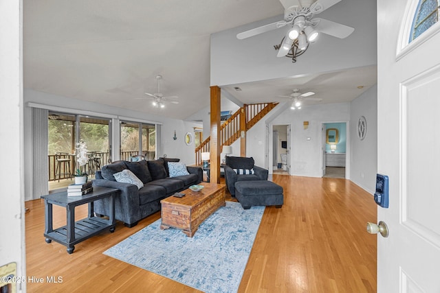 1005 Pirate Cove Cir, Oriental, NC 28571 - living room featuring a ceiling fan, stairs, high vaulted ceiling, and light wood-type flooring