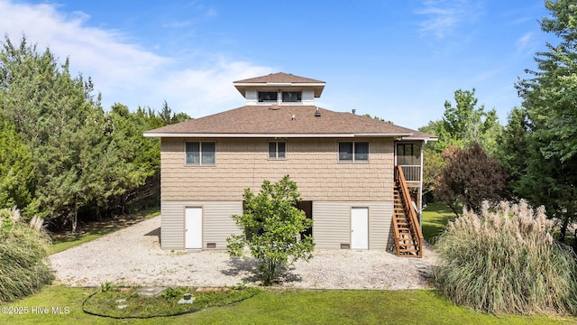 1005 Pirate Cove Cir, Oriental, NC 28571 - rear view of house featuring stairway, a sunroom, roof with shingles, and a yard
