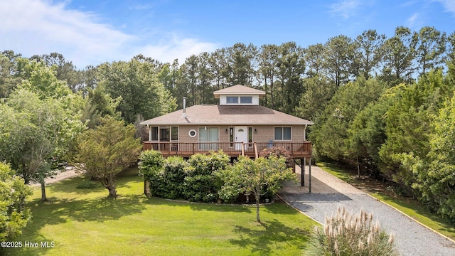 1005 Pirate Cove Cir, Oriental, NC 28571 - view of front of home with dirt driveway, a carport, a wooden deck, and a front yard