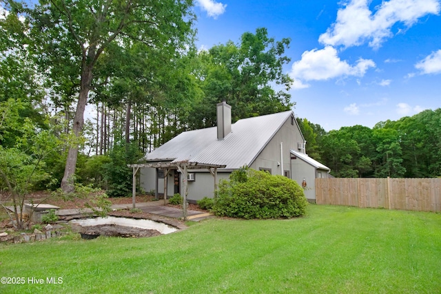 4969 Redman Rd, Rocky Mount, NC 27803 - rear view of house with a pergola, a chimney, and metal roof
