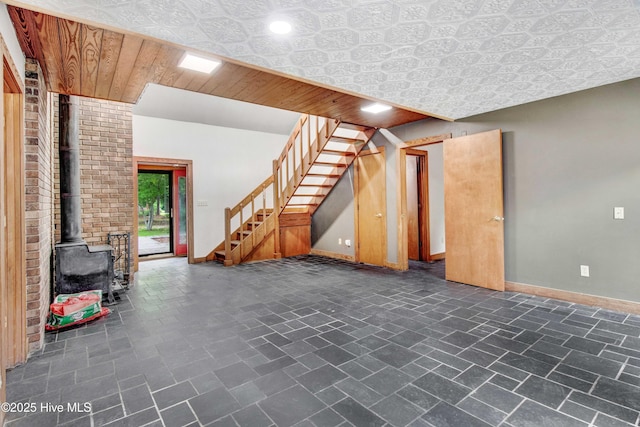 4969 Redman Rd, Rocky Mount, NC 27803 - unfurnished living room featuring baseboards, a wood stove, stairway, and recessed lighting