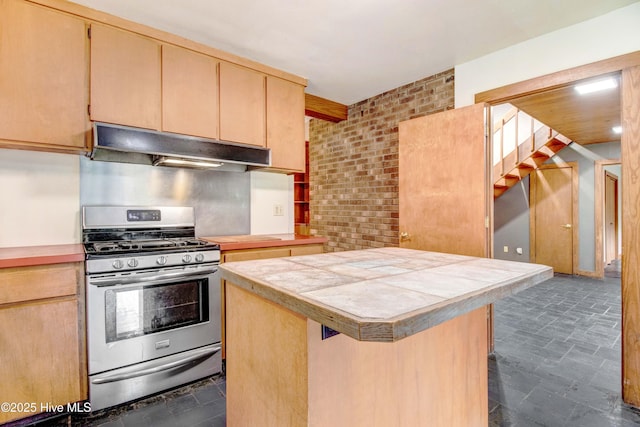 4969 Redman Rd, Rocky Mount, NC 27803 - kitchen with stainless steel range with gas stovetop, under cabinet range hood, a center island, and light brown cabinetry