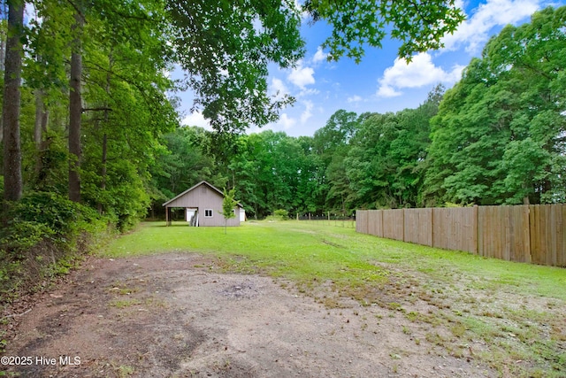 4969 Redman Rd, Rocky Mount, NC 27803 - view of yard with dirt driveway, a forest view, a pole building, and a detached garage