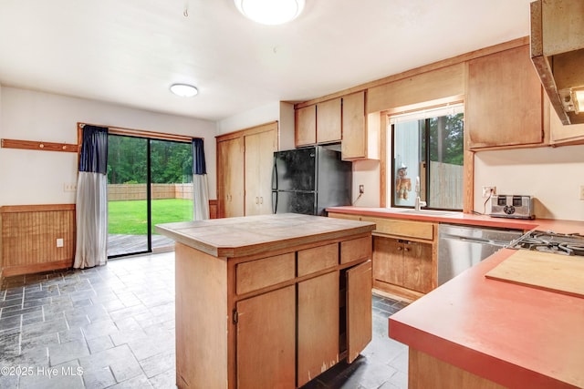 4969 Redman Rd, Rocky Mount, NC 27803 - kitchen featuring freestanding refrigerator, dishwasher, light stone finish flooring, and a kitchen island