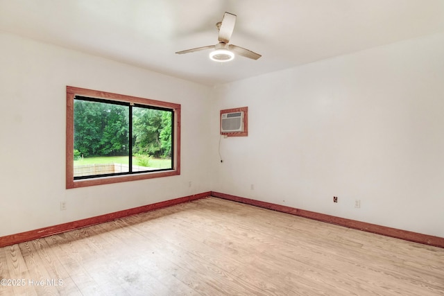 4969 Redman Rd, Rocky Mount, NC 27803 - spare room featuring light wood finished floors, ceiling fan, baseboards, and an AC wall unit