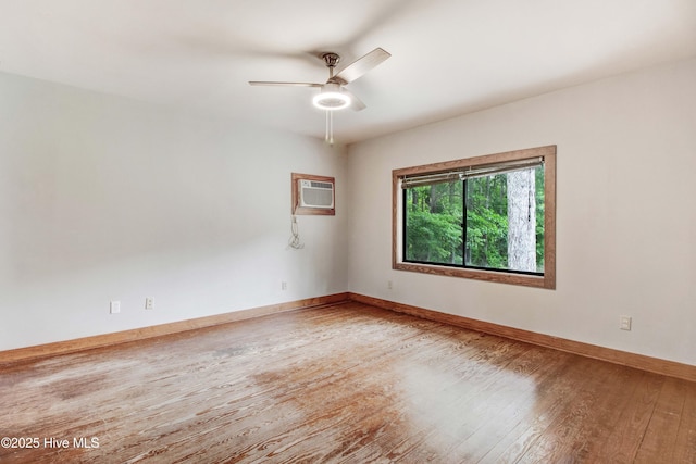 4969 Redman Rd, Rocky Mount, NC 27803 - unfurnished room with hardwood / wood-style flooring, ceiling fan, baseboards, and a wall mounted air conditioner