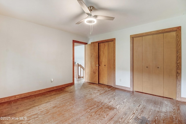 4969 Redman Rd, Rocky Mount, NC 27803 - unfurnished bedroom featuring light wood-style floors, two closets, baseboards, and ceiling fan