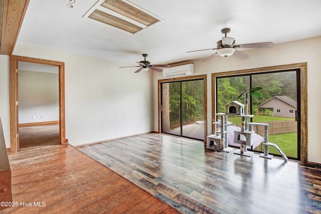 4969 Redman Rd, Rocky Mount, NC 27803 - unfurnished room featuring a wall mounted air conditioner, wood finished floors, ceiling fan, and baseboards