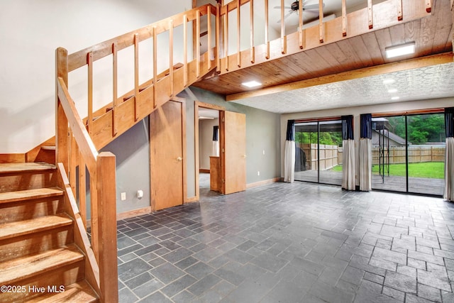 4969 Redman Rd, Rocky Mount, NC 27803 - unfurnished living room featuring stairway, baseboards, and stone tile floors