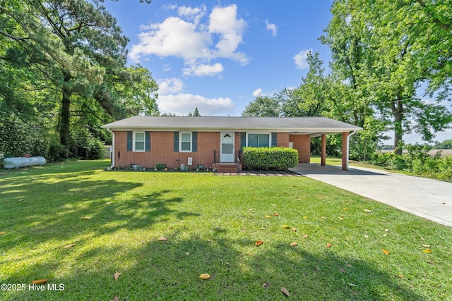 460 S NC-111 Hwy, Chinquapin, NC 28521 - ranch-style home with entry steps, concrete driveway, brick siding, an attached carport, and a front yard