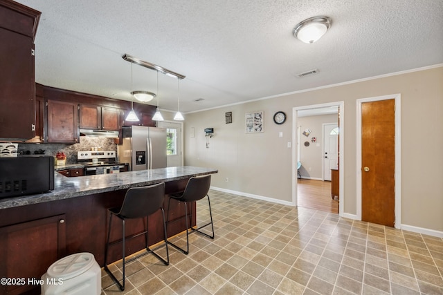 460 S NC-111 Hwy, Chinquapin, NC 28521 - kitchen featuring stainless steel appliances, a textured ceiling, ornamental molding, under cabinet range hood, and a kitchen breakfast bar