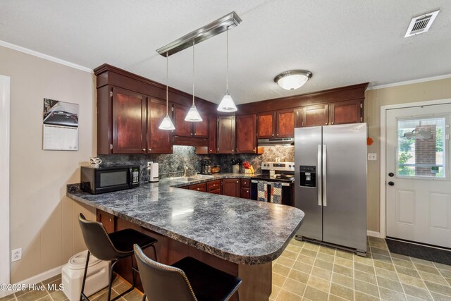 460 S NC-111 Hwy, Chinquapin, NC 28521 - kitchen with appliances with stainless steel finishes, under cabinet range hood, a peninsula, dark countertops, and tasteful backsplash