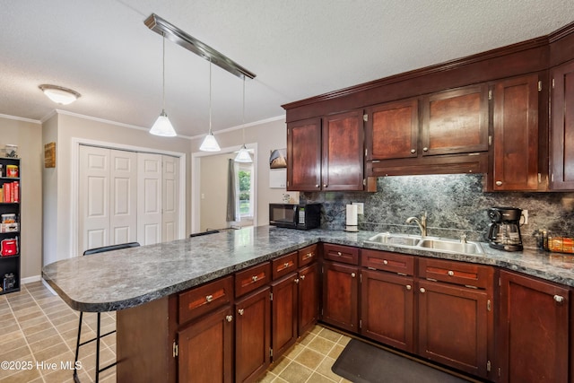 460 S NC-111 Hwy, Chinquapin, NC 28521 - kitchen featuring black microwave, a sink, a peninsula, tasteful backsplash, and a textured ceiling