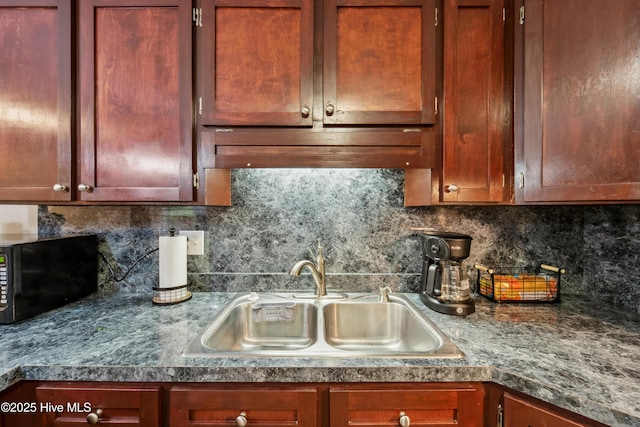 460 S NC-111 Hwy, Chinquapin, NC 28521 - kitchen with black microwave, a sink, tasteful backsplash, and dark countertops
