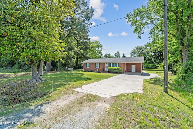 460 S NC-111 Hwy, Chinquapin, NC 28521 - view of front of house featuring driveway, brick siding, an attached carport, and a front yard
