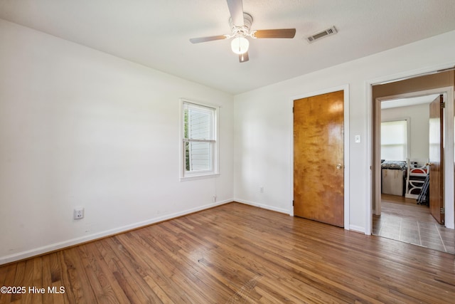 460 S NC-111 Hwy, Chinquapin, NC 28521 - unfurnished bedroom with wood finished floors, baseboards, and a ceiling fan
