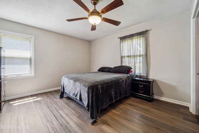 460 S NC-111 Hwy, Chinquapin, NC 28521 - bedroom featuring wood finished floors, multiple windows, baseboards, and a textured ceiling