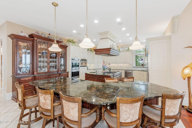 291 Live Oak Rd, Newport, NC 28570 - kitchen featuring a large island, custom range hood, recessed lighting, appliances with stainless steel finishes, and a breakfast bar area