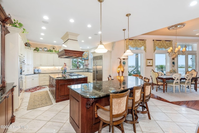 291 Live Oak Rd, Newport, NC 28570 - kitchen featuring stainless steel built in fridge, a spacious island, custom range hood, decorative backsplash, and a chandelier