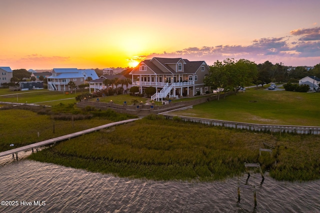 291 Live Oak Rd, Newport, NC 28570 - back of property at dusk featuring a water view and a yard
