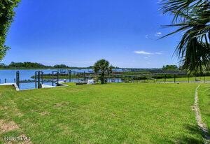 1205 Kings Lndg, Hampstead, NC 28443 - view of grassy yard featuring a water view and a dock