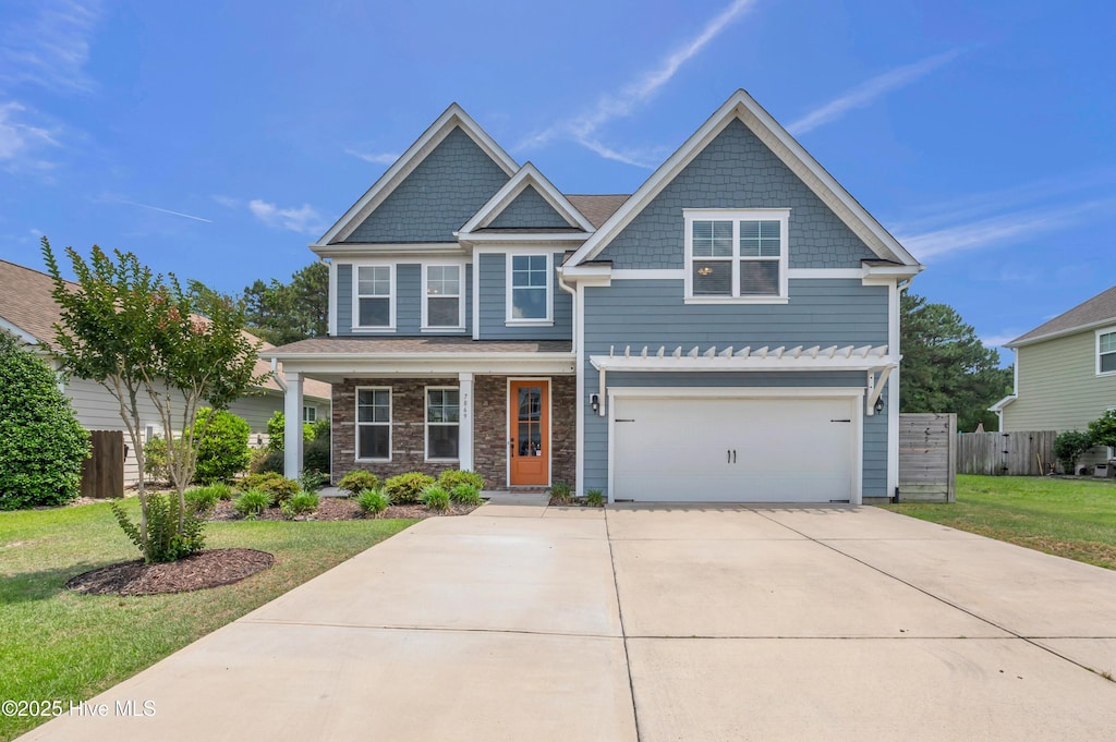 7869 Champlain Dr, Wilmington, NC 28412 - craftsman inspired home with concrete driveway, a garage, covered porch, and stone siding