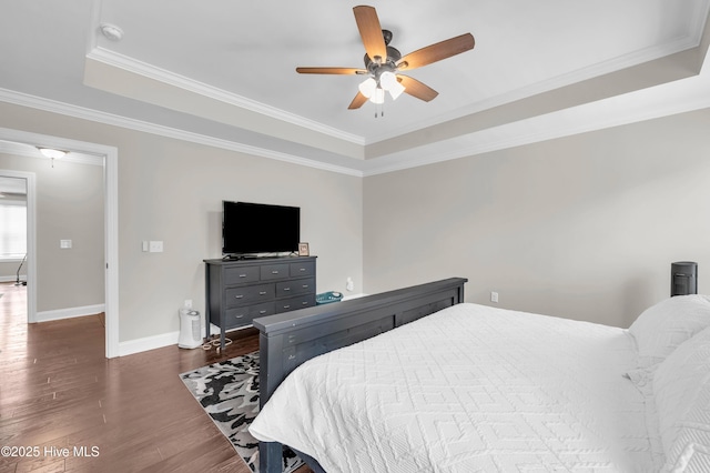7869 Champlain Dr, Wilmington, NC 28412 - bedroom with a raised ceiling, dark wood-type flooring, baseboards, ornamental molding, and ceiling fan